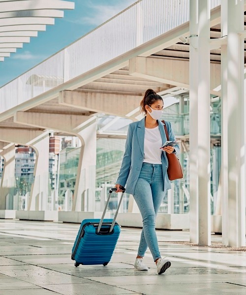 woman-with-luggage-during-pandemic-airport